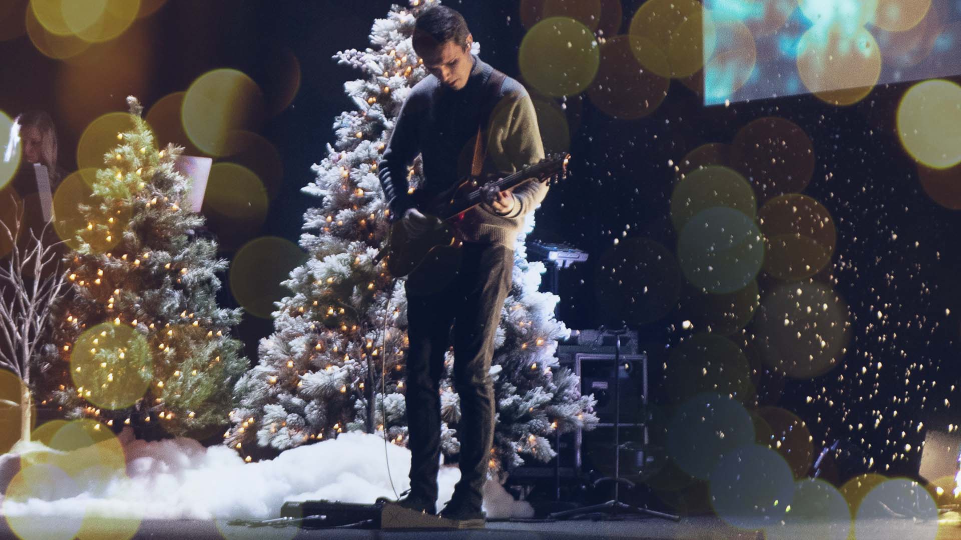 christmas worship leader playing guitar